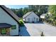Exterior view of the house featuring an extensive driveway and detached garage at 783 Blackberry Trl, Lawrenceville, GA 30043