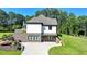 View of this home with a lush lawn that slopes gently upward and is accented with manicured landscaping at 783 Blackberry Trl, Lawrenceville, GA 30043