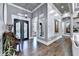 Elegant foyer featuring hardwood floors, ornate mirror, and chandelier lighting at 783 Blackberry Trl, Lawrenceville, GA 30043