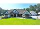 Stunning brick home with a well-manicured lawn, three car garage, and elegant details at 783 Blackberry Trl, Lawrenceville, GA 30043