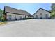 Spacious driveway leading to a modern home with a detached two-car garage featuring glass-paneled doors at 783 Blackberry Trl, Lawrenceville, GA 30043
