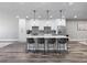 Open concept kitchen with a large island, modern appliances, pendant lighting, and hardwood flooring at 783 Blackberry Trl, Lawrenceville, GA 30043