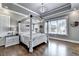 Serene main bedroom with a canopy bed, large windows, and hardwood floors at 783 Blackberry Trl, Lawrenceville, GA 30043