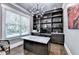 Home office with built-in shelves, marble desk, and ample natural light at 783 Blackberry Trl, Lawrenceville, GA 30043