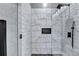 A glass-enclosed shower features marble tiling, black hardware, and a built-in niche at 783 Blackberry Trl, Lawrenceville, GA 30043