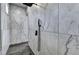 This walk-in shower features beautiful marble-look tile, rain shower head and hand held wand at 783 Blackberry Trl, Lawrenceville, GA 30043