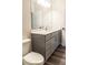 Bathroom featuring grey vanity with a quartz countertop, a mirror, lighting fixture, and wood-look flooring at 2008 Main Nw St, Atlanta, GA 30318