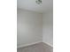 Neutral bedroom with a carpeted floor, white trim, standard lighting fixture, and electrical outlet on the wall at 2008 Main Nw St, Atlanta, GA 30318
