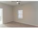 Simple bedroom featuring a ceiling fan, window, neutral carpet, and access to a bathroom at 2008 Main Nw St, Atlanta, GA 30318