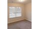 Bedroom featuring neutral walls, a window with blinds, and soft carpeting at 2008 Main Nw St, Atlanta, GA 30318