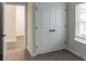 Cozy bedroom featuring neutral carpet, a large window for natural light, and closet with double doors at 2008 Main Nw St, Atlanta, GA 30318