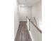 Long hallway featuring wood-look flooring, white walls, white banister, and natural lighting at 2008 Main Nw St, Atlanta, GA 30318