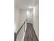 Upstairs hallway with wood floors, white walls, and white doors at 2008 Main Nw St, Atlanta, GA 30318