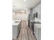 Bright kitchen with stainless steel appliances, grey cabinets, and granite countertops and island at 2008 Main Nw St, Atlanta, GA 30318