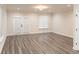 Spacious living room area with hardwood floors and lots of natural light from the doors at 2008 Main Nw St, Atlanta, GA 30318