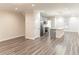 Open-concept living space flows into a modern kitchen with stainless steel appliances and island seating at 2008 Main Nw St, Atlanta, GA 30318