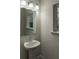 Powder room with pedestal sink, window, and decorative lighting at 2008 Main Nw St, Atlanta, GA 30318