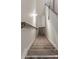 Carpeted staircase with wooden handrails leading to the next level, featuring neutral decor and ample lighting at 2008 Main Nw St, Atlanta, GA 30318