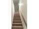 Carpeted staircase with wooden railing and white trim at 2008 Main Nw St, Atlanta, GA 30318