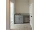 Stylish wet bar with granite countertop and gray cabinetry, enhancing the entertainment space at 2008 Main Nw St, Atlanta, GA 30318