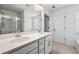Bright bathroom featuring a glass-enclosed shower and double sink vanity with a white countertop at 2230 Mulsanne Dr, Lithonia, GA 30058