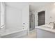 Bright bathroom featuring a tub, glass enclosed shower, and double sink vanity with white countertop at 2230 Mulsanne Dr, Lithonia, GA 30058