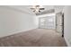 Spacious bedroom with a tray ceiling, neutral carpet, and natural light from two windows at 2230 Mulsanne Dr, Lithonia, GA 30058
