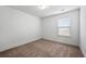 Bedroom with a large window and neutral carpeting providing lots of natural light at 2230 Mulsanne Dr, Lithonia, GA 30058