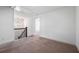 Bedroom with a large window, neutral carpeting, and a modern light fixture at 2230 Mulsanne Dr, Lithonia, GA 30058