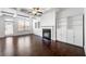 Bright living room featuring coffered ceilings, a fireplace, hardwood floors, and built-in shelving at 2230 Mulsanne Dr, Lithonia, GA 30058