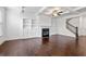 Open-concept living room with coffered ceiling, fireplace, hardwood floors, and access to stairs at 2230 Mulsanne Dr, Lithonia, GA 30058