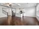 Open-concept living space with hardwood floors and a kitchen island with white cabinets at 2230 Mulsanne Dr, Lithonia, GA 30058
