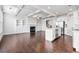 Open-concept living space with fireplace, hardwood floors, kitchen island, and stainless steel appliances at 2230 Mulsanne Dr, Lithonia, GA 30058