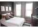 Well-lit bedroom with a desk, natural light from two windows, decor, wood-style flooring, and modern amenities at 898 Oak Sw St # 1410, Atlanta, GA 30310