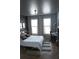 Bedroom with a gray accent wall, hardwood floors, lots of light from the windows, and a desk for working at 898 Oak Sw St # 1410, Atlanta, GA 30310