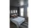 Comfortable bedroom features a large bed, wood-style floor, natural light and decor which creates a serene atmosphere at 898 Oak Sw St # 1410, Atlanta, GA 30310