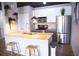 Modern kitchen boasts stainless steel appliances, stone countertops, pendant lighting, and breakfast bar seating at 898 Oak Sw St # 1410, Atlanta, GA 30310