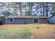 A beautiful home exterior showcasing a lush, green backyard with a sliding glass door at 9090 Dorsey Rd, Riverdale, GA 30274