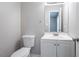 This bathroom includes a toilet, sink, vanity and mirror at 9090 Dorsey Rd, Riverdale, GA 30274