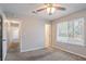 Bedroom with ceiling fan and a window overlooking the yard at 9090 Dorsey Rd, Riverdale, GA 30274