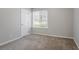 Bedroom with neutral walls, carpeted floors and a window at 9090 Dorsey Rd, Riverdale, GA 30274
