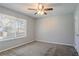 This bedroom has a ceiling fan and a window at 9090 Dorsey Rd, Riverdale, GA 30274
