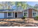 Home exterior showcasing a brick accent and manicured landscaping at 9090 Dorsey Rd, Riverdale, GA 30274