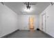 This is a garage space, illuminated with overhead lighting, and features a utility door and a pedestrian door at 9090 Dorsey Rd, Riverdale, GA 30274