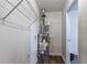 This is a hot water heater in a utility area, featuring a wire rack for storage at 9090 Dorsey Rd, Riverdale, GA 30274