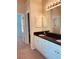Bright bathroom features a double sink vanity with granite countertops and white cabinetry at 2030 Calmwater Ct, Suwanee, GA 30024