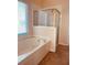 Bathroom with a soaking tub with jets and a glass enclosed shower at 2030 Calmwater Ct, Suwanee, GA 30024
