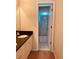 Bright bathroom features a vanity with a black granite countertop and a door to the shower at 2030 Calmwater Ct, Suwanee, GA 30024
