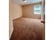 Simple bedroom with neutral walls, carpeted floor and a single window at 2030 Calmwater Ct, Suwanee, GA 30024
