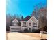 Charming two-story home with a manicured lawn and a two-car garage at 2030 Calmwater Ct, Suwanee, GA 30024